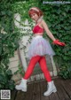 A woman in a red and white outfit posing for a picture.